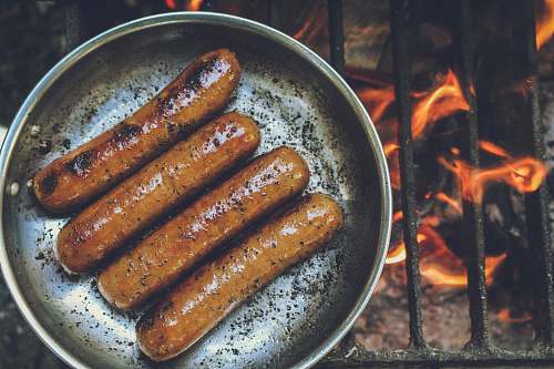 hot dog cooked sausage on round grey pan leisure activities